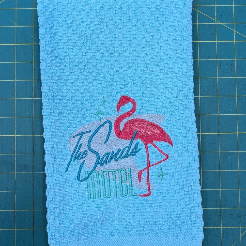 The Sands Motel Pink Flamingo Retro Embroidered Blue Waffle Weave Hand Towel